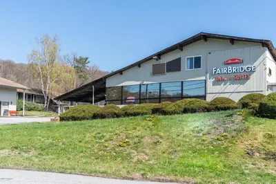 a building with a sign on the side of it at FairBridge Inn and Suites West Point in Highland Falls