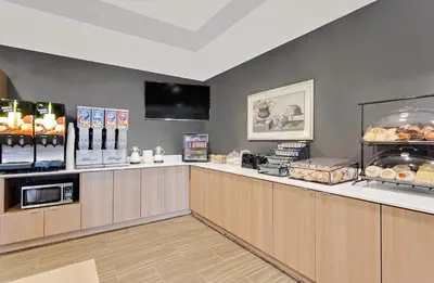 a fast food restaurant with a counter with food at Microtel Inn & Suites by Wyndham Middletown in Middletown