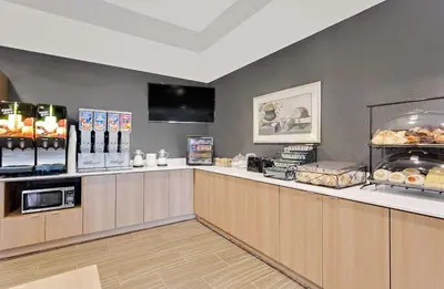 a fast food restaurant with a counter with food at Microtel Inn & Suites by Wyndham Middletown in Middletown