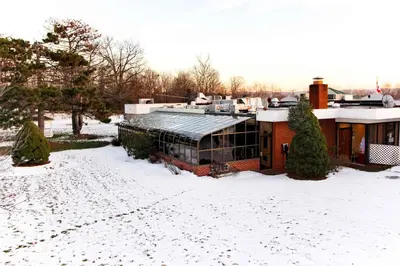 a house in the snow with a snow covered yard at Newburgh Inn in Newburgh