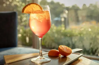 a drink with an orange slice on a table at Hilton Garden Inn Philadelphia-Fort Washington in Fort Washington