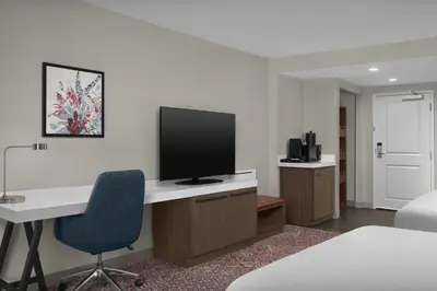 a room with a desk with a television on it at Hilton Garden Inn Philadelphia-Fort Washington in Fort Washington
