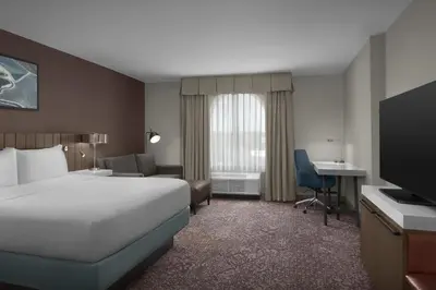 a hotel room with a bed and a desk at Hilton Garden Inn Philadelphia-Fort Washington in Fort Washington