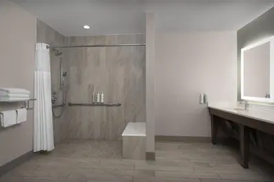 a bathroom with a shower and a sink at Hilton Garden Inn Philadelphia-Fort Washington in Fort Washington