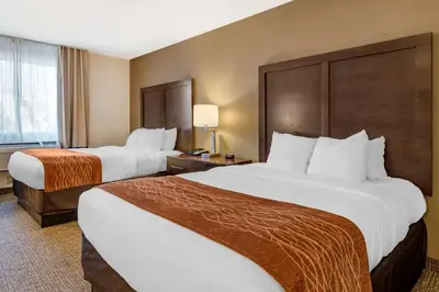 a hotel room with two beds and a window at Comfort Inn Williamsport in Williamsport