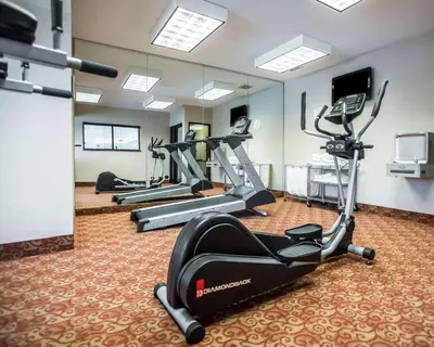 a gym with several tread machines in a room at Comfort Inn Williamsport in Williamsport
