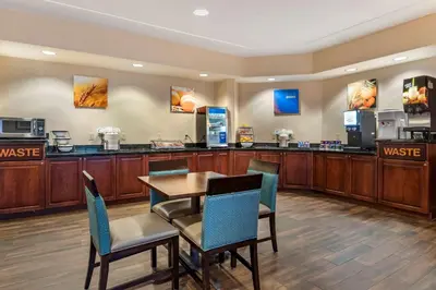 a waiting area with a table and chairs in a hotel room at Comfort Inn Williamsport in Williamsport