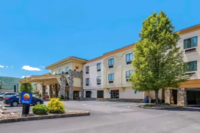 a hotel with a car parked in a parking lot at Comfort Inn Williamsport in Williamsport