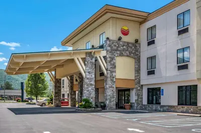 a hotel front of a building with a parking lot at Comfort Inn Williamsport in Williamsport