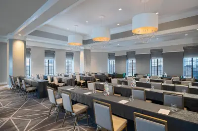 a large room with tables and chairs and chandeliers at Kimpton Hotel Palomar Philadelphia by IHG in Philadelphia