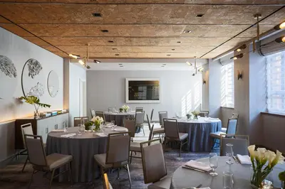 a dining room with tables and chairs in a room at Kimpton Hotel Palomar Philadelphia by IHG in Philadelphia