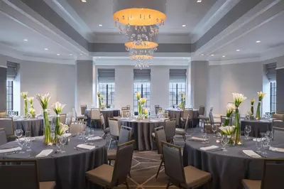 a banquet room with tables and chairs and chandeliers at Kimpton Hotel Palomar Philadelphia by IHG in Philadelphia
