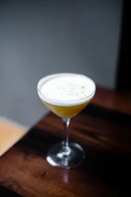 a martini glass sitting on top of a wooden table at Kimpton Hotel Palomar Philadelphia by IHG in Philadelphia