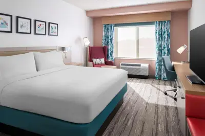 a hotel room with a bed and a desk at Hilton Garden Inn Rockaway in Rockaway