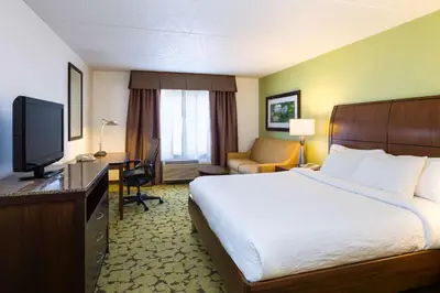 a hotel room with a bed and a television at Hilton Garden Inn Edison/Raritan Center in Edison