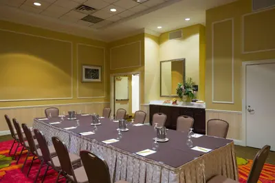 a conference room with a long table and chairs at Hilton Garden Inn Edison/Raritan Center in Edison