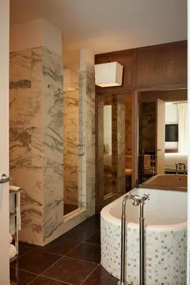 a bathroom with a bath tub in a room at The Mercer in New York