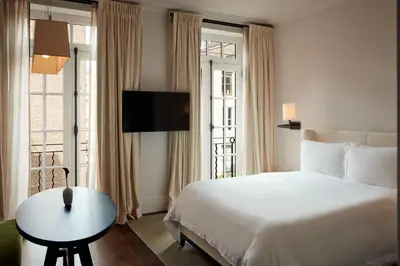 a hotel room with a bed and a table and a window at The Mercer in New York