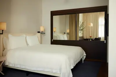 a bedroom with a large white bed and a large mirror at The Mercer in New York