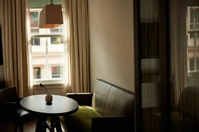 a room with a table and a chair and a window at The Mercer in New York