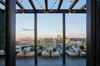 a balcony with couches and a view of a city at citizenM New York Bowery in New York