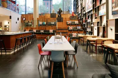 a dining room with tables and chairs at citizenM New York Bowery in New York