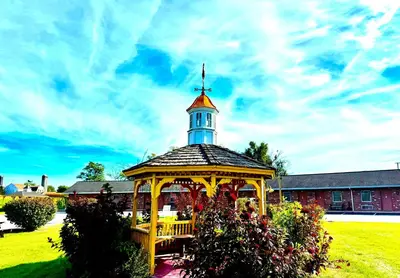 a gazebo with a tower on top of a building at Weathervane Motor Court in Ronks