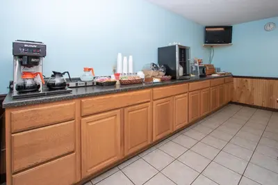 a kitchen with wooden cabinets and a counter top at Eastbrook Inn in Ronks