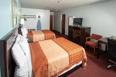 a hotel room with two beds and a television at Eastbrook Inn in Ronks