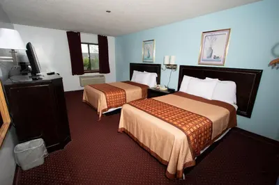 a hotel room with two beds and a flat screen tv at Eastbrook Inn in Ronks