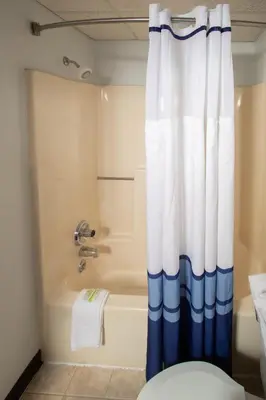a bathroom with a tub and a shower curtain at Eastbrook Inn in Ronks