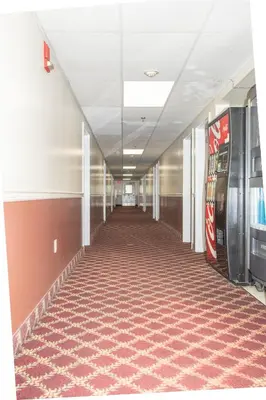an empty hallway in an office building with vending machines at Eastbrook Inn in Ronks