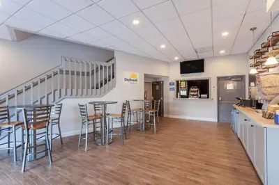 a restaurant with tables and chairs in a room at Days Inn & Suites by Wyndham Lancaster Amish Country in Lancaster