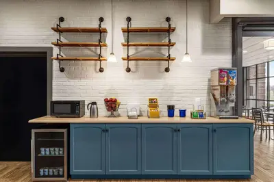 a kitchen with a blue island in a room at Days Inn & Suites by Wyndham Lancaster Amish Country in Lancaster