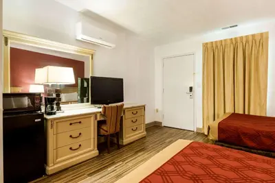 a hotel room with a bed and a desk with a television at Econo Lodge Inn & Suites Lake Harmony - Pocono Mountains Area in White Haven