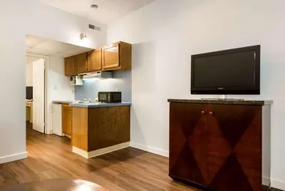 a kitchen with a flat screen tv on a wall at Econo Lodge Inn & Suites Lake Harmony - Pocono Mountains Area in White Haven