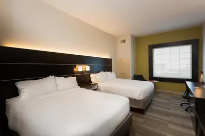 a hotel room with two beds and a desk at Holiday Inn Express Hotel & Suites Reading by IHG in Reading