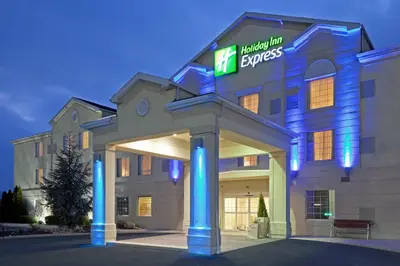 a hotel with a sign on the front of a building at Holiday Inn Express Hotel & Suites Reading by IHG in Reading