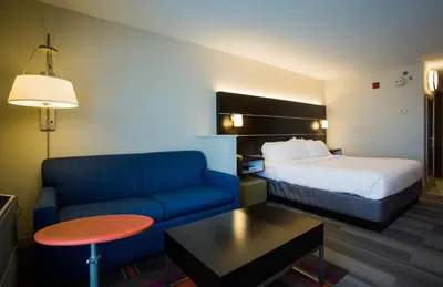 a hotel room with a bed and a couch at Holiday Inn Express Hotel & Suites Reading by IHG in Reading