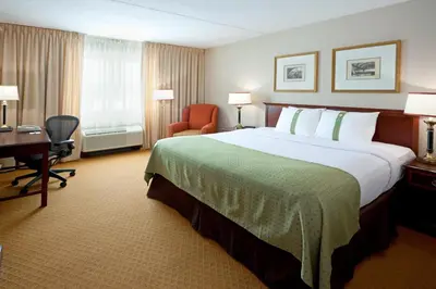 a hotel room with a large bed and a desk at Holiday Inn Budd Lake - Rockaway Area by IHG in Budd Lake