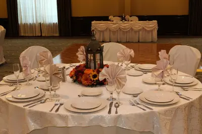 a table with a white table cloth with plates and glasses at Holiday Inn Budd Lake - Rockaway Area by IHG in Budd Lake