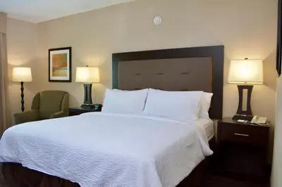 a hotel room with a large bed and a chair at Holiday Inn Budd Lake - Rockaway Area by IHG in Budd Lake