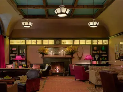 a living room with a fireplace and a fire place at The Greenwich Hotel in New York