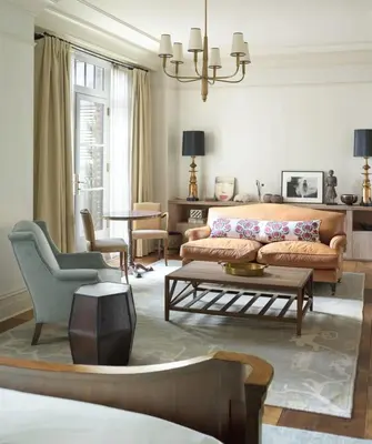 a living room with a couch and a table at The Greenwich Hotel in New York