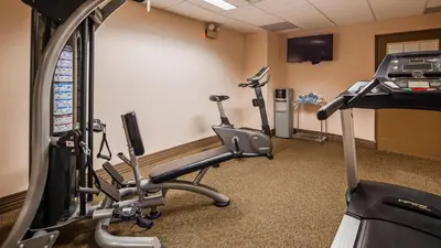 a gym with two exercise bikes and a treadmill at Best Western Philadelphia South - West Deptford Inn in Thorofare