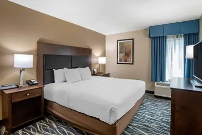 a hotel room with a large bed and a television at Comfort Inn & Suites Newark - Wilmington in Newark