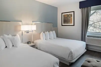 a hotel room with two beds and a window at The Gatsby Hotel in New York