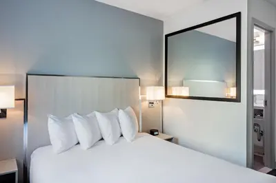 a hotel room with a large bed with white pillows at The Gatsby Hotel in New York