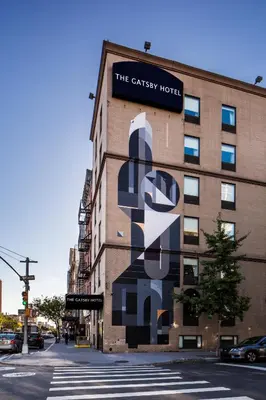 a building with a large mural on the side of it at The Gatsby Hotel in New York