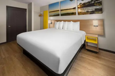 a large white bed in a hotel room at Days Inn by Wyndham Wurtsboro in Wurtsboro